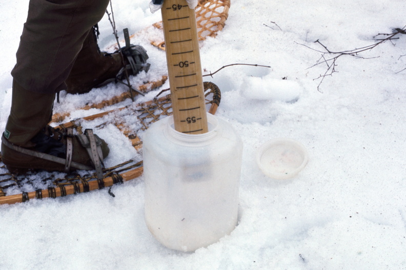Measuring snow water equivalent with an Adirondack snow sampling tube in 1973 snow 1 april 1973.jpg